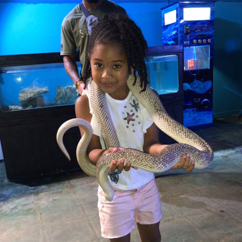 young guest holding snake